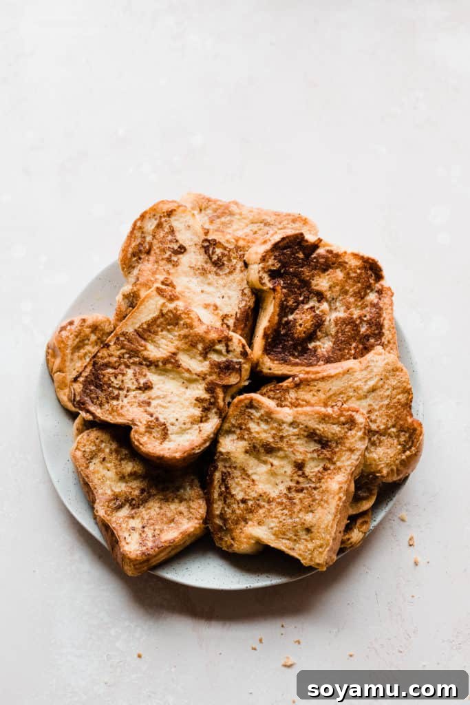 Indulgent Vanilla Rum French Toast with Blackberries and Pears 4 A plate of golden brown french toast slices