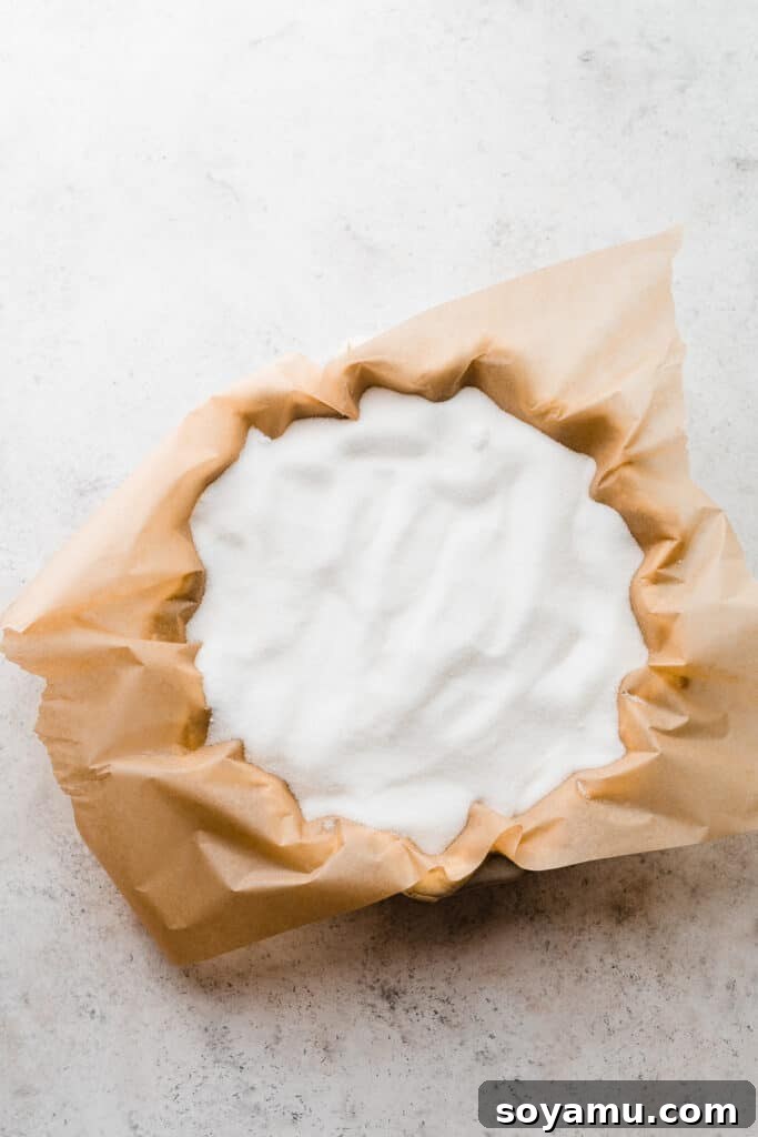 The Easiest 3-Ingredient Pie Crust Ever 14 A pie crust with parchment paper and sugar filling it to weigh it down.