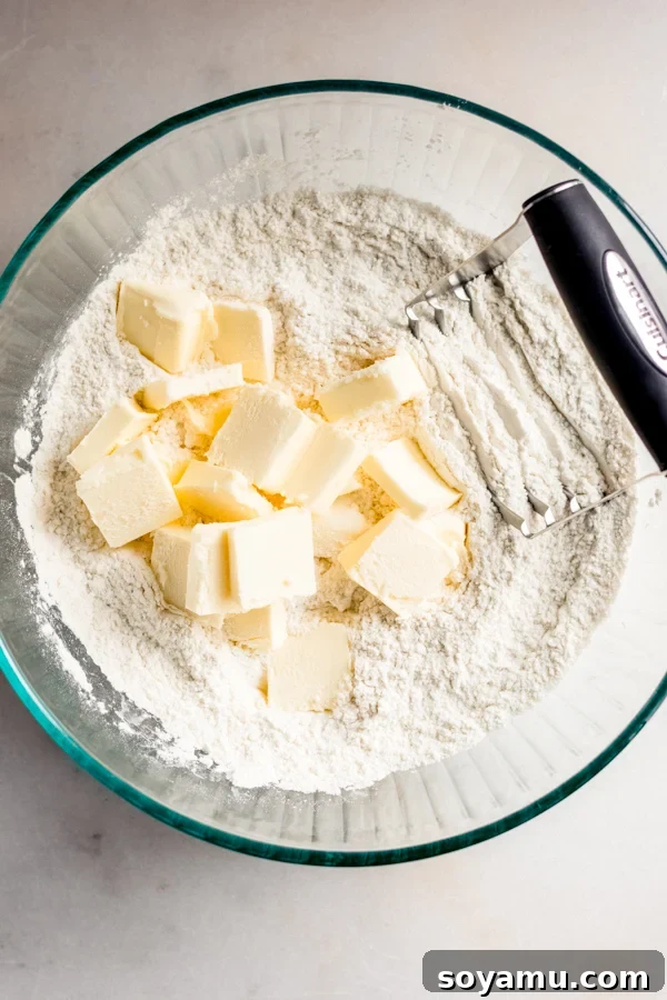 The Easiest 3-Ingredient Pie Crust Ever 5 Cubed cold butter in a bowl of flour.