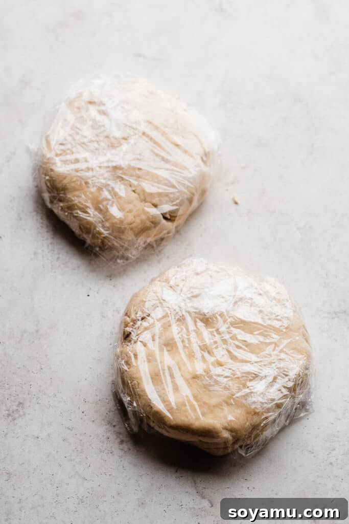 The Easiest 3-Ingredient Pie Crust Ever 8 Two discs of pie dough wrapped in plastic wrap.
