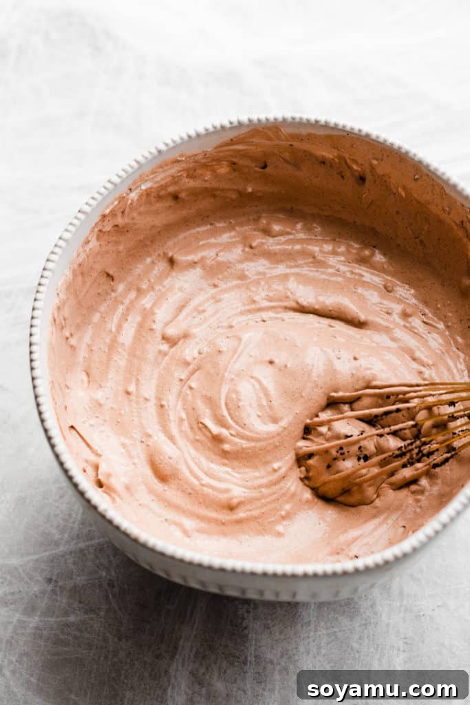 A bowl of chocolate pudding being whisked
