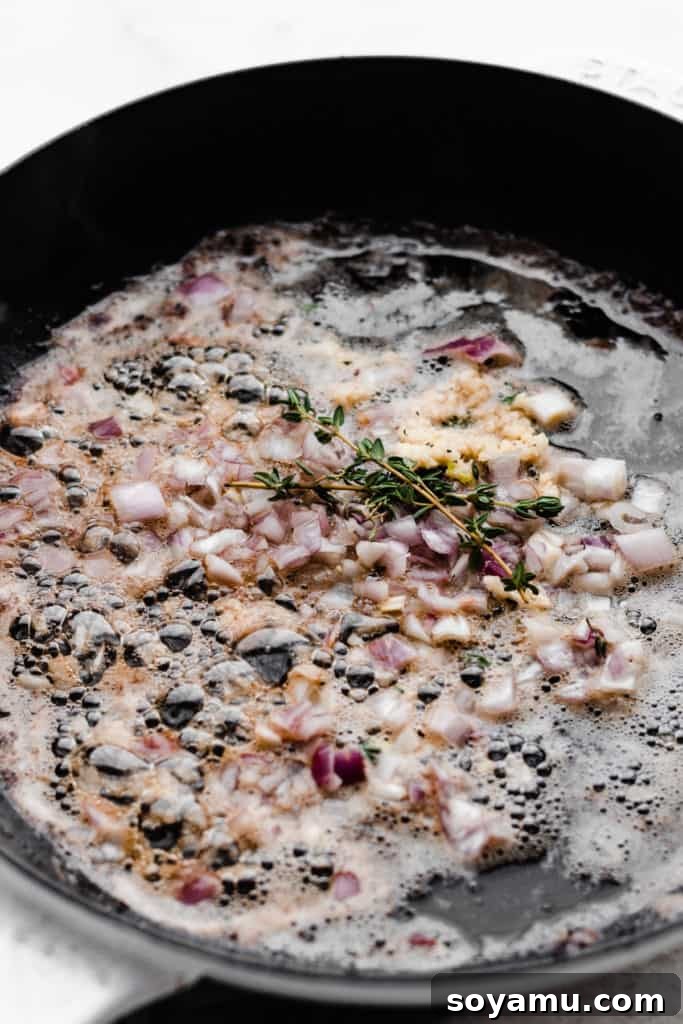 Tender Lamb Chops with Shallot-Thyme Pan Sauce and Creamy Garlic Smashed Potatoes 7 Minced shallot, garlic, and thyme sizzling in a skillet, creating the aromatic base for the pan sauce.