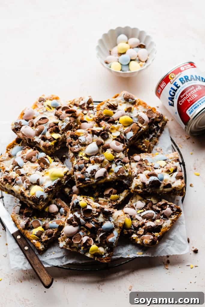A vibrant platter of freshly baked Seven Layer Bars, beautifully garnished with colorful Easter egg candies.