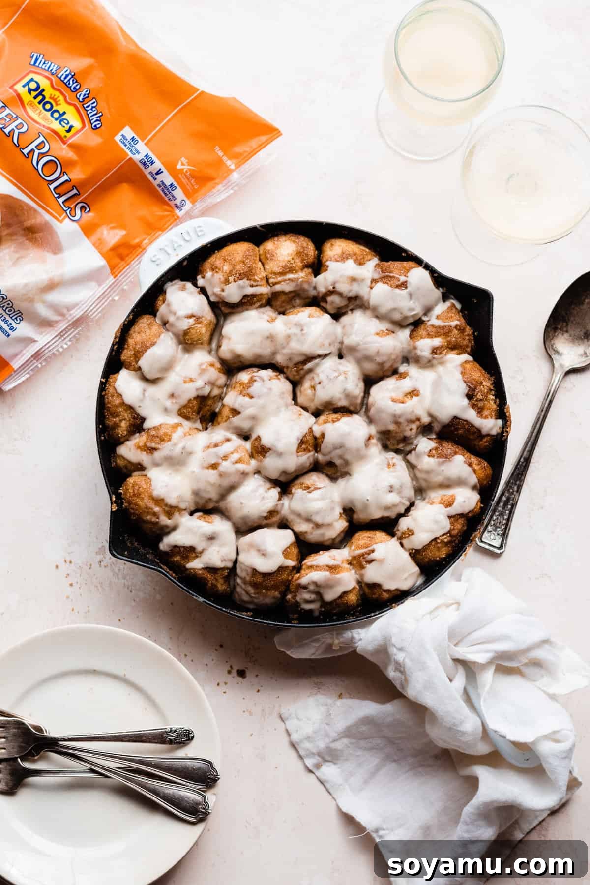 Gooey Skillet Cinnamon Roll Goodness 6 A close-up shot of the skillet cinnamon roll bake, glistening with fresh glaze, showcasing its soft texture and delicious appeal.
