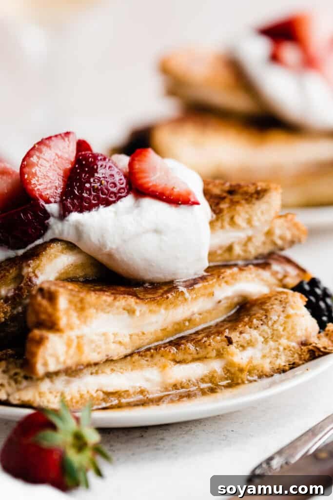 Decadent Stuffed French Toast 9 A close-up on a stack of beautifully cooked stuffed french toast, ready to be served.