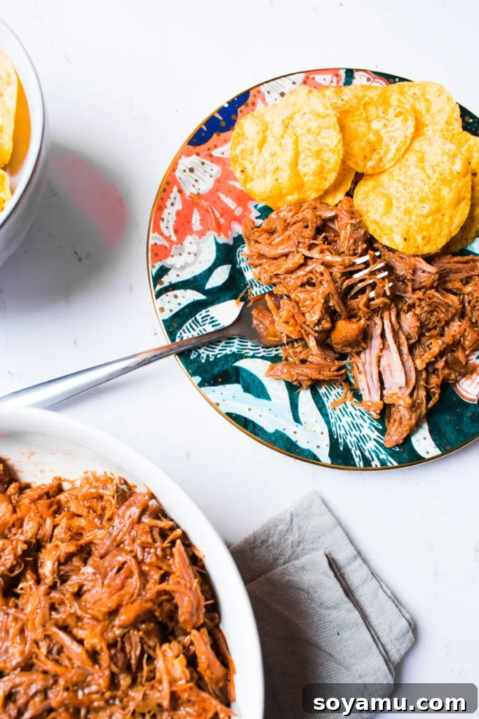 Perfectly Tender Instant Pot Pulled Pork 4 A vibrant and appetizing spread for a pulled pork taco bar, featuring various toppings and tortillas.