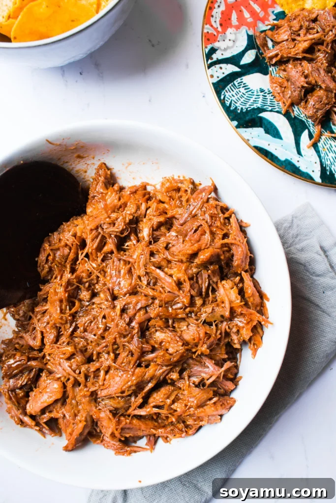 Perfectly Tender Instant Pot Pulled Pork 7 A freshly cooked batch of pulled pork, steaming and ready for shredding, showcasing its readiness.