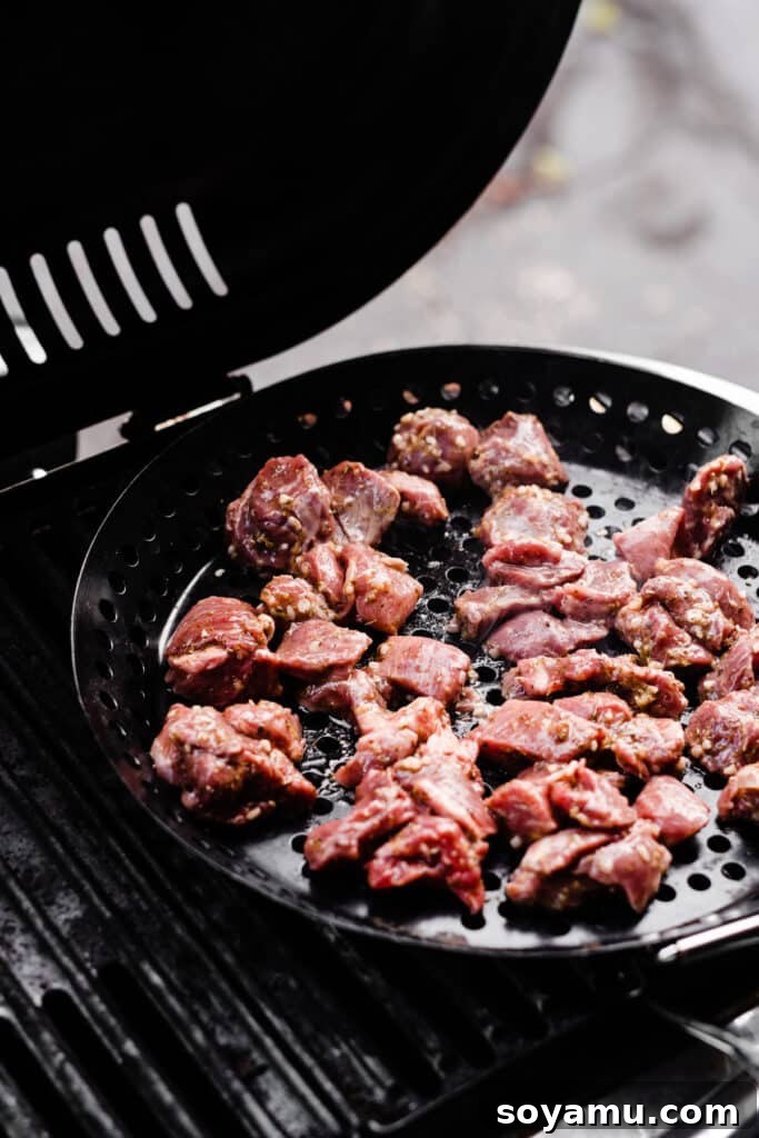 Lamb Souvlaki Tacos 3 A grill pan with cubed lamb meat on the grill.