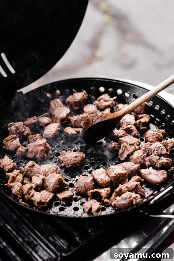Lamb Souvlaki Tacos 4 A grill pan with the cubed lamb cooking on the grill.