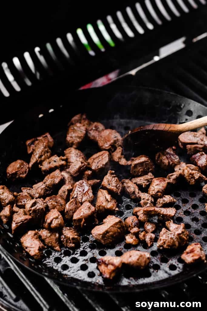Lamb Souvlaki Tacos 5 A grill pan of lamb meat, cooked, on the grill.