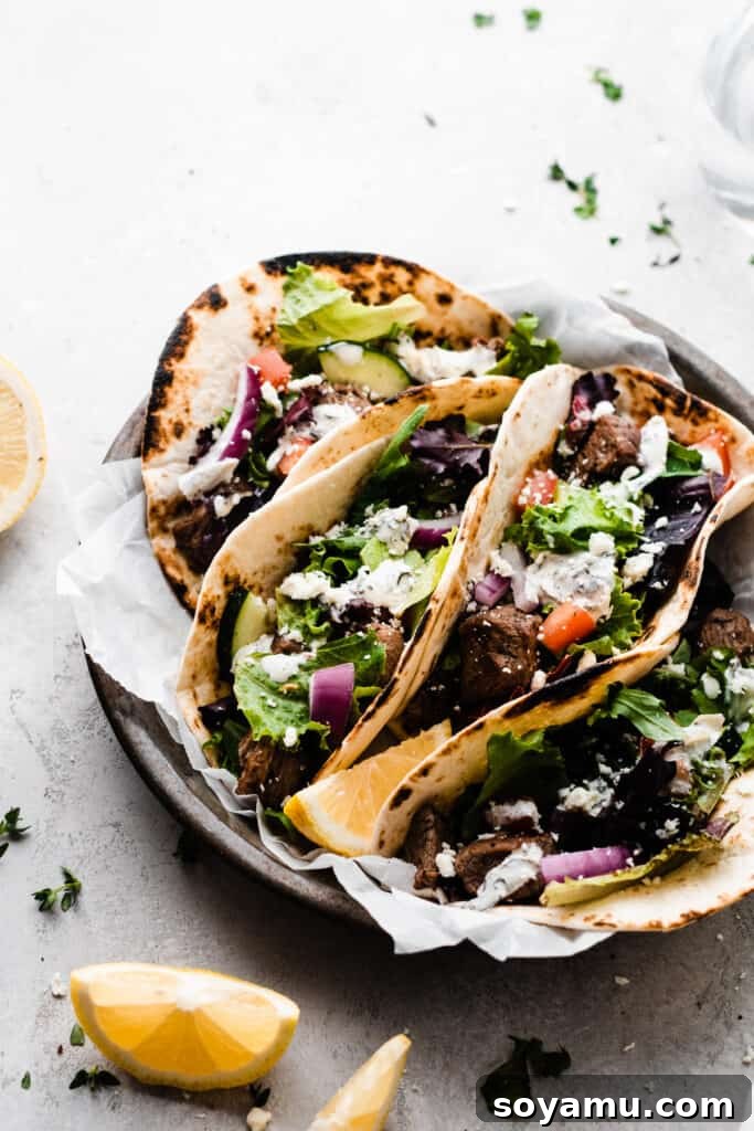 Lamb Souvlaki Tacos 7 A metal tray filled with the tacos, with all the fixings.