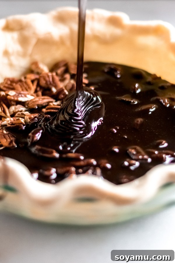 Assembling the Chocolate Bourbon Pecan Pie Pie filling poured into pie crust.