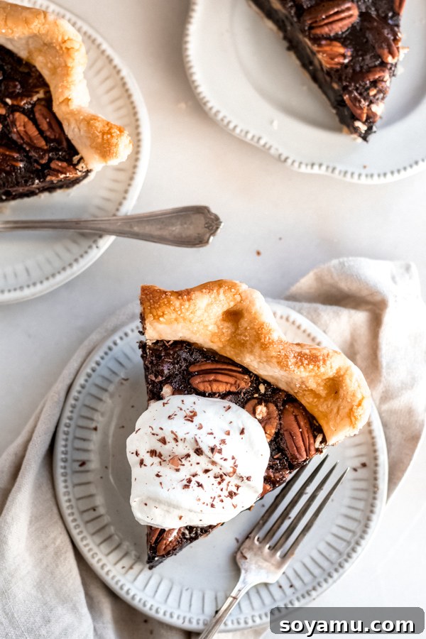 The Perfect Slice: Chocolate Bourbon Pecan Pie with Whipped Cream A slice of chocolate bourbon pecan pie with a dollop of whipped cream.