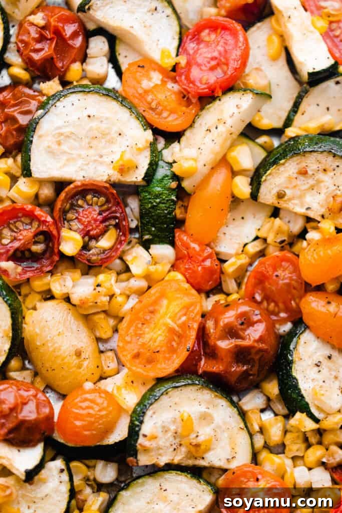 Vibrant Roasted Vegetables for Meal Prep 2 A close-up of the roasted medley of tomatoes, corn, and zucchini, perfectly caramelized and vibrant.