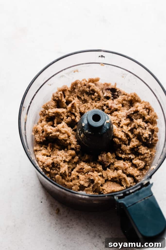 Candied Sweet Potato Casserole with Pecan Streusel 6 The bowl of a food processor containing the streusel topping mixture.