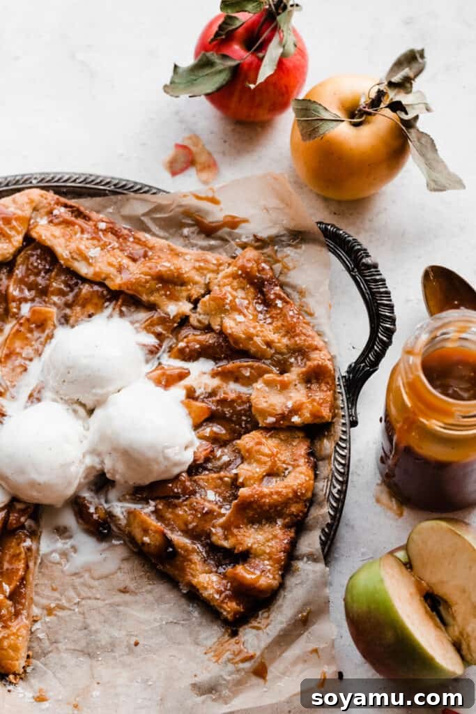 Salted Caramel Apple Galette Recipe 10 A metal tray holding slices of Salted Caramel Apple Galette, with one slice missing, highlighting its golden crust and delicious caramel topping.