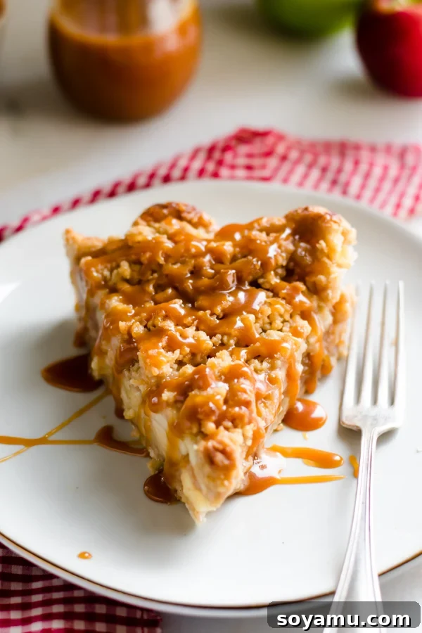 Autumns Best Apple Recipes Fresh from the Orchard 16 A perfect slice of golden Dutch Caramel Apple Pie, artfully drizzled with caramel sauce, presented on a white plate.