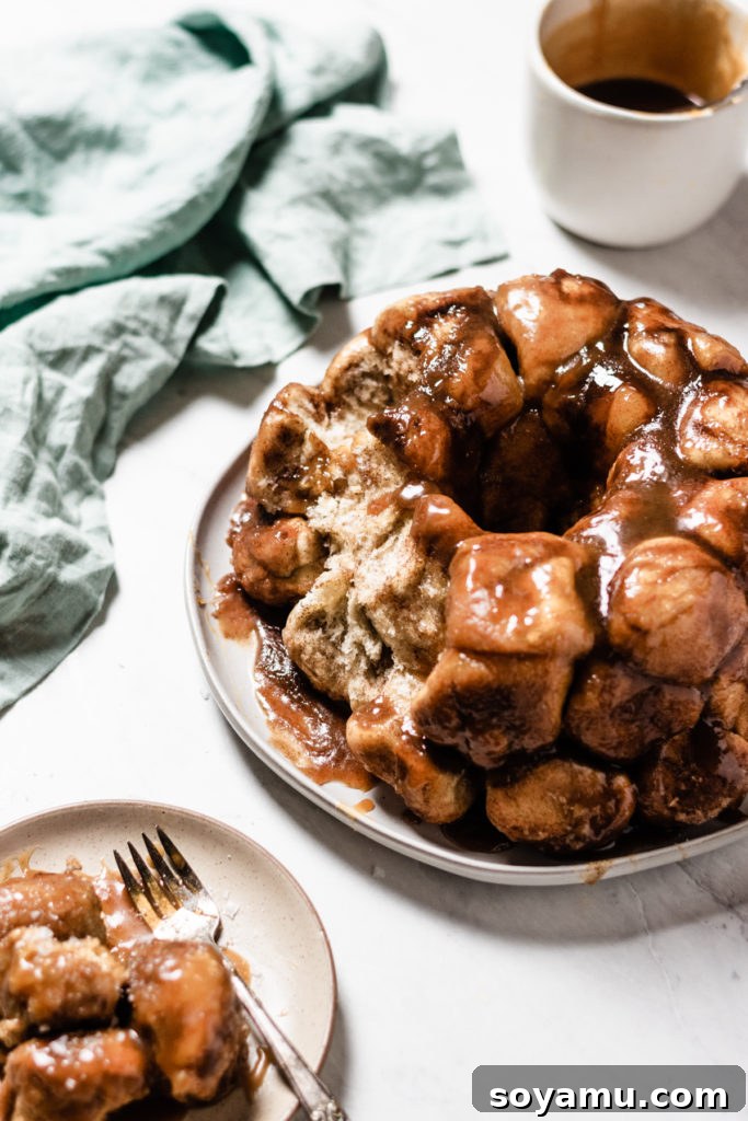 Autumns Best Apple Recipes Fresh from the Orchard 18 A golden-brown Apple Cider Caramel Monkey Bread on a serving plate, ready to be pulled apart and enjoyed.