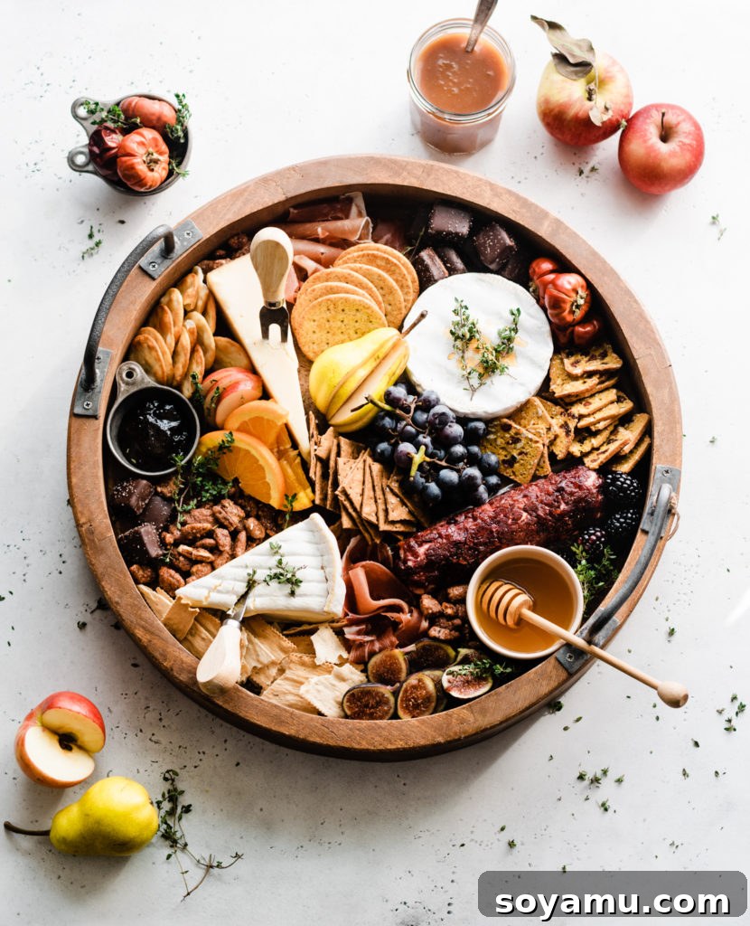 Autumns Best Apple Recipes Fresh from the Orchard 6 A lavish fall harvest cheeseboard, artfully arranged with an array of crackers, gourmet cheeses, cured meats, fresh and dried fruits (including apples), and nuts.