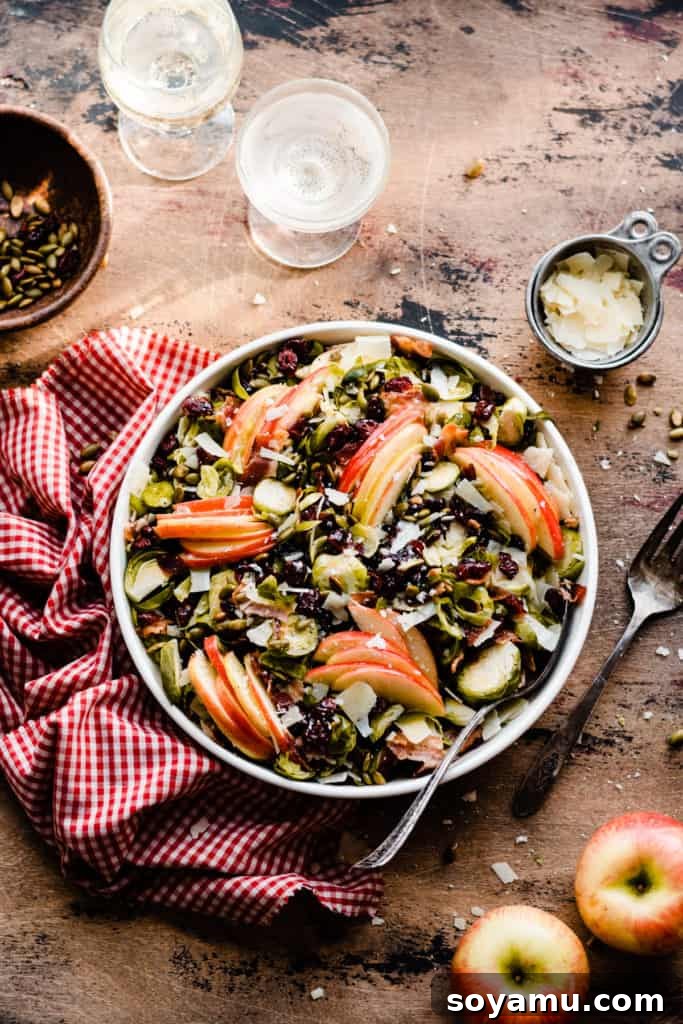 Autumns Best Apple Recipes Fresh from the Orchard 9 A large bowl brimming with a colorful Brussels Sprouts and Apple Salad, perfectly mixed and ready to serve.