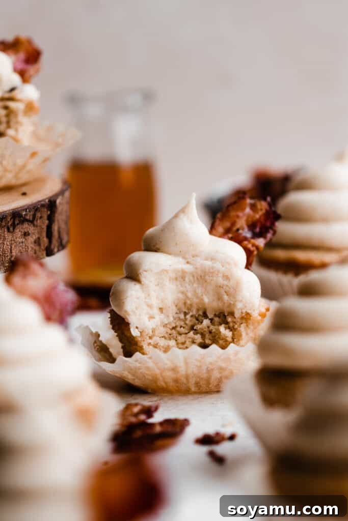 Brown Butter Maple Bacon Perfection 8 A cupcake with a bite taken out of it.