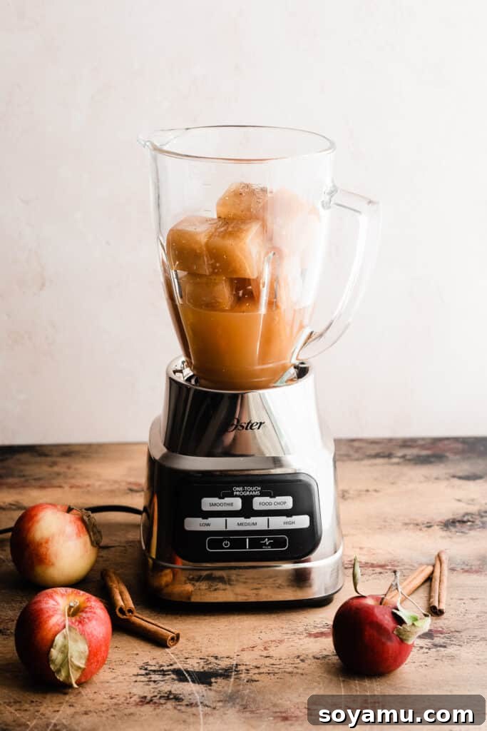 Spiked or Not Apple Cider Slushies 4 A blender filled with fresh apple cider and frozen apple cider cubes.