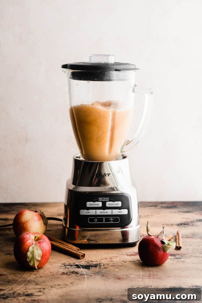Spiked or Not Apple Cider Slushies 5 A blender filled with the blended apple cider slushy mix.