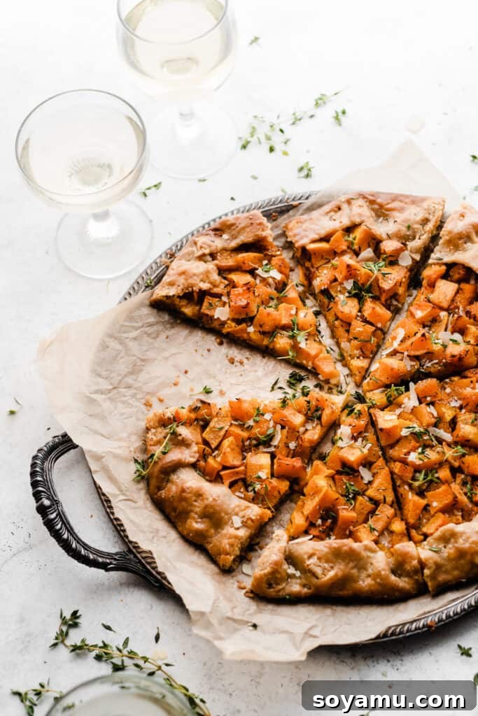Asiago Parmesan Butternut Squash Galette 7 A beautifully baked butternut squash galette, with a slice already removed, showing the rich filling and perfectly browned crust.