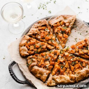 A sliced butternut squash galette on a vintage metal tray, ready to be served.