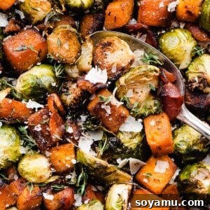 A close-up of the roasted veggies being scooped with a serving spoon.