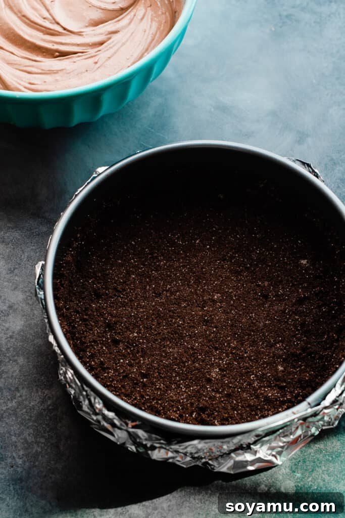 Baileys Infused Chocolate Ganache Cheesecake 4 Chocolate cookie crust pressed neatly into the springform pan, ready for baking.