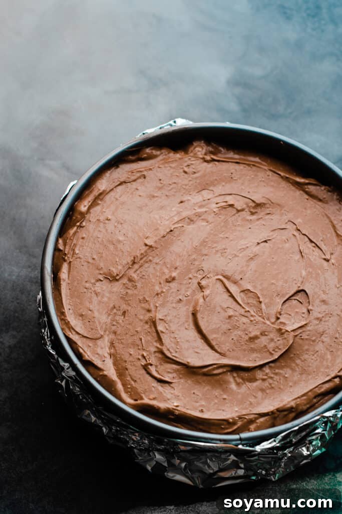 Baileys Infused Chocolate Ganache Cheesecake 6 The unbaked Baileys cheesecake batter evenly poured into the springform pan.