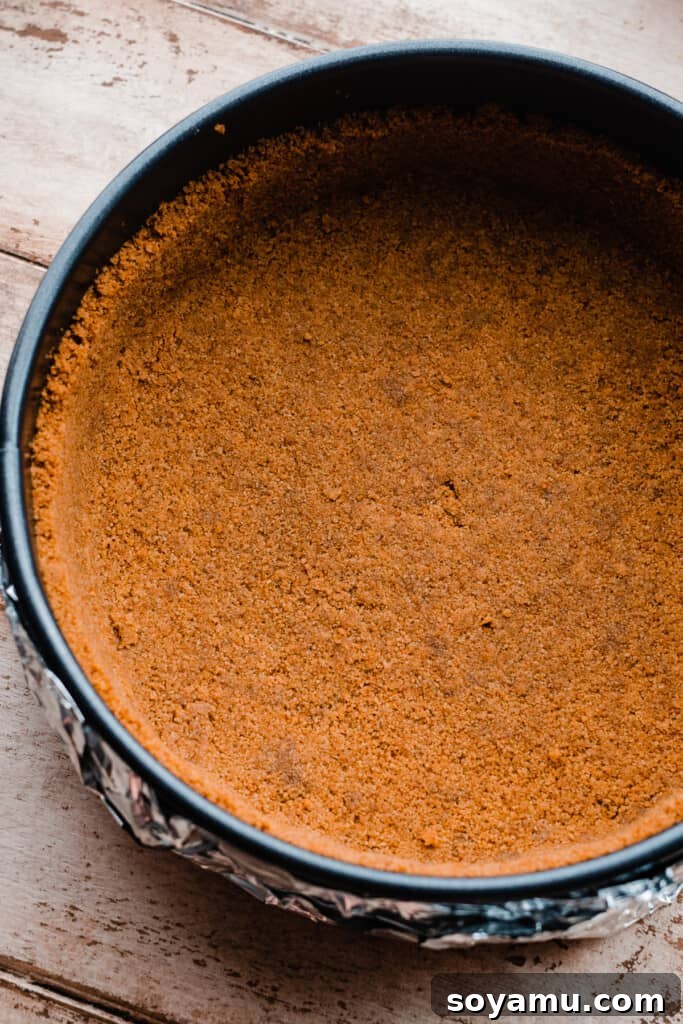 Decadent Salted Caramel Apple Pie Cheesecake 6 The perfectly baked cinnamon graham cracker crust in a 9-inch springform pan, ready for the cheesecake filling.