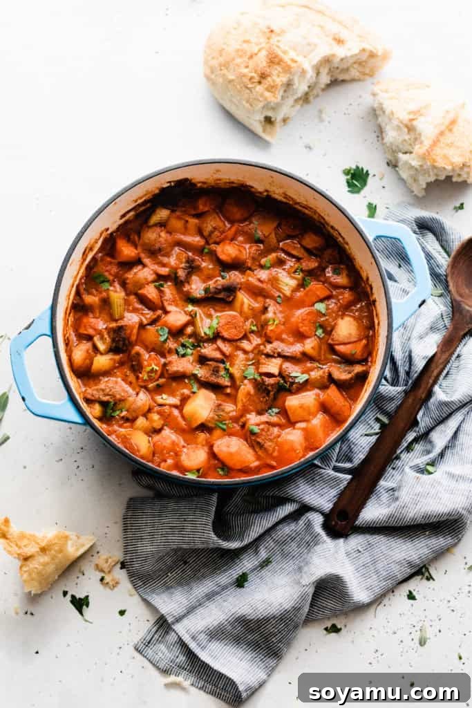 Best Beef Stew (Instant Pot + Oven) - This Beef Stew is saucy, hearty, and made with simple, good-for-you ingredients like potatoes, carrots, beef, tomato juice, and spices. Make it in the Instant Pot in a flash or in the oven, cooked low and slow. Both cooking methods give drool-worthy results. Don't forget the crusty bread for dipping! #instantpotrecipes #instantpotbeefstew #beefstew #healthyrecipes #dinnerrecipes #easyrecipes #bluebowlrecipes | bluebowlrecipes.com Rich beef stew cooked in an Instant Pot, served directly from a blue cooking pot, ready to be enjoyed.