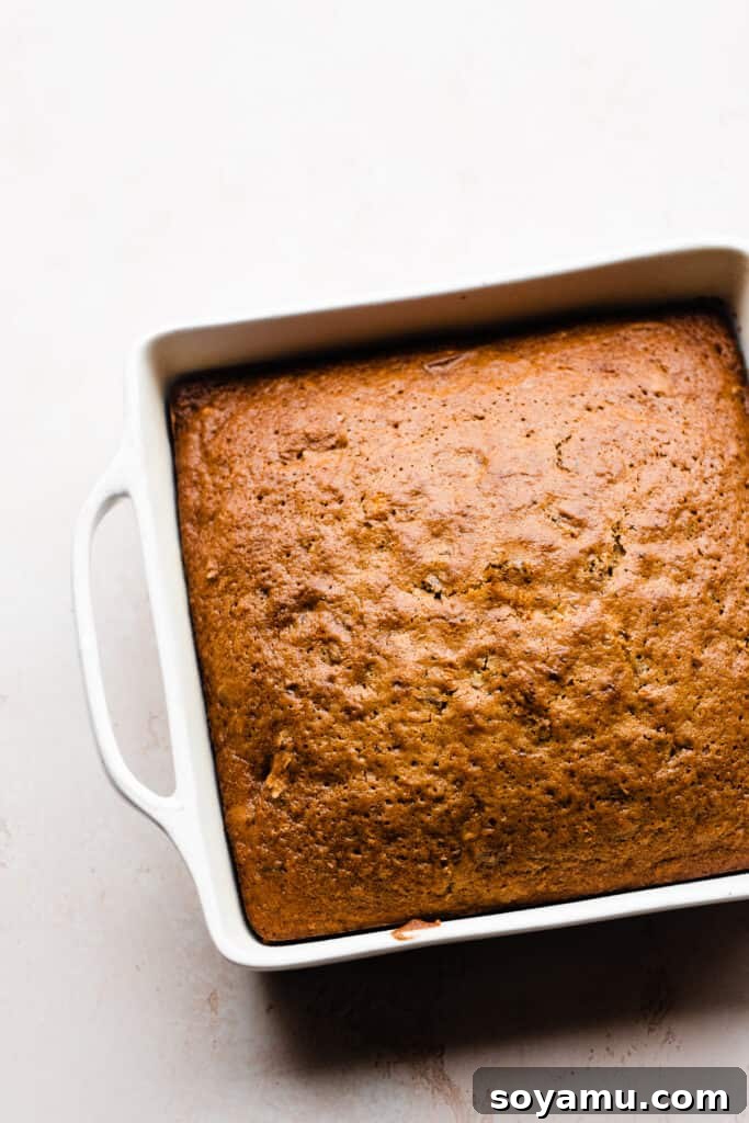 Caramelized Brown Butter Mini Carrot Cakes 8 A beautifully baked carrot cake, golden brown and perfectly risen, resting in a 9-inch square baking pan.