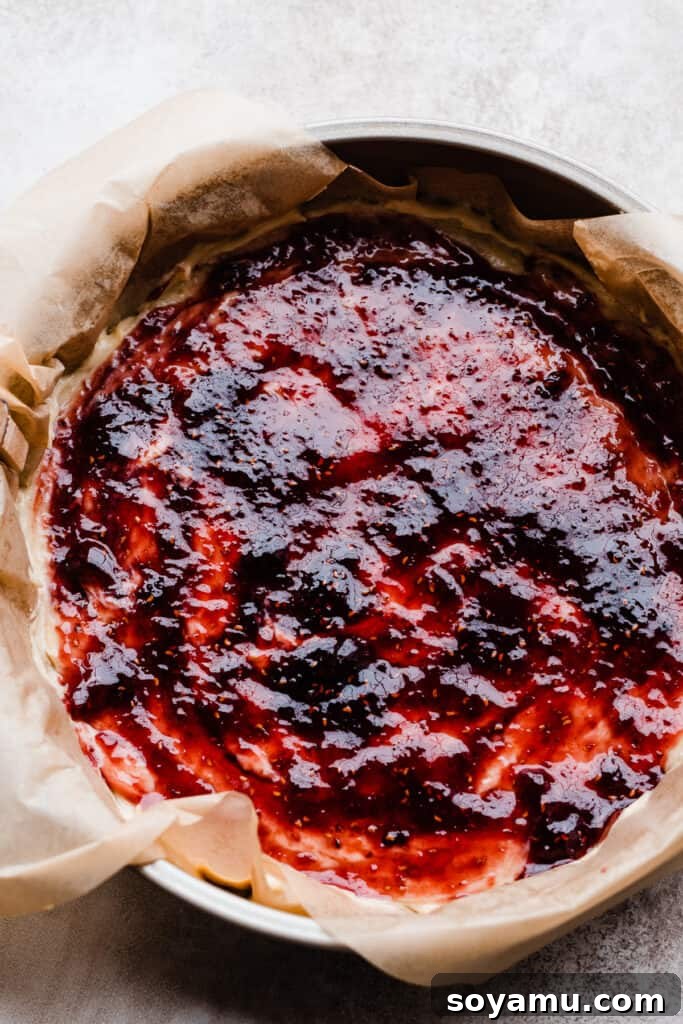 Zesty One-Bowl Raspberry Lemon Coffee Cake 6 Cake batter topped with raspberry preserves.
