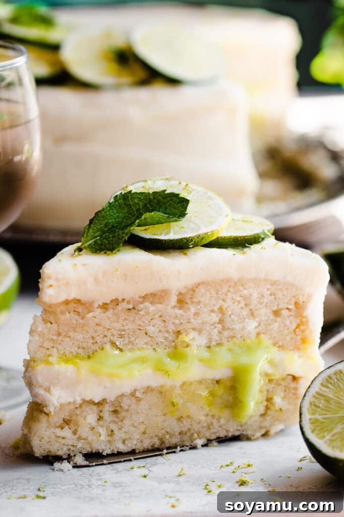 Zesty Mojito Cake with Spiked Rum Buttercream 3 A close-up of a slice of cake on a cake server, showcasing the layers and frosting.