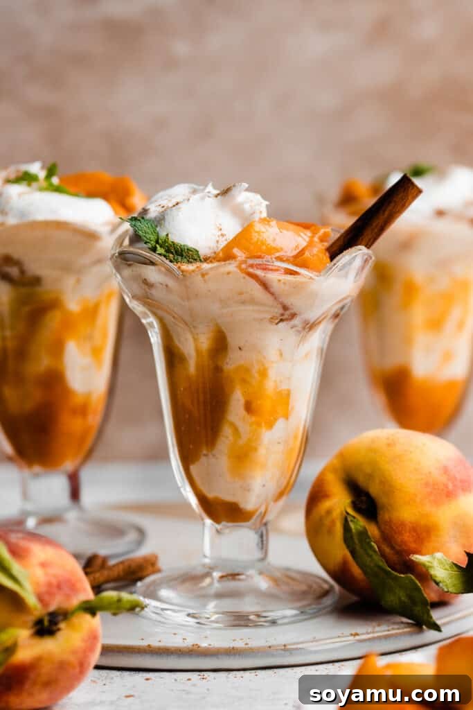 Swirled Homemade Peach Pie Milkshake 2 Three sundae glasses full of peach milkshake, swirled with homemade peach sauce and topped with whipped cream and fresh peach slices.