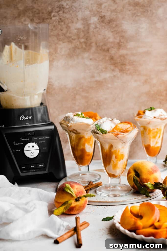 Swirled Homemade Peach Pie Milkshake 8 Three perfectly poured peach milkshakes in elegant glasses, with a blender filled with more milkshake mixture visible in the softly blurred background, ready for enjoyment.