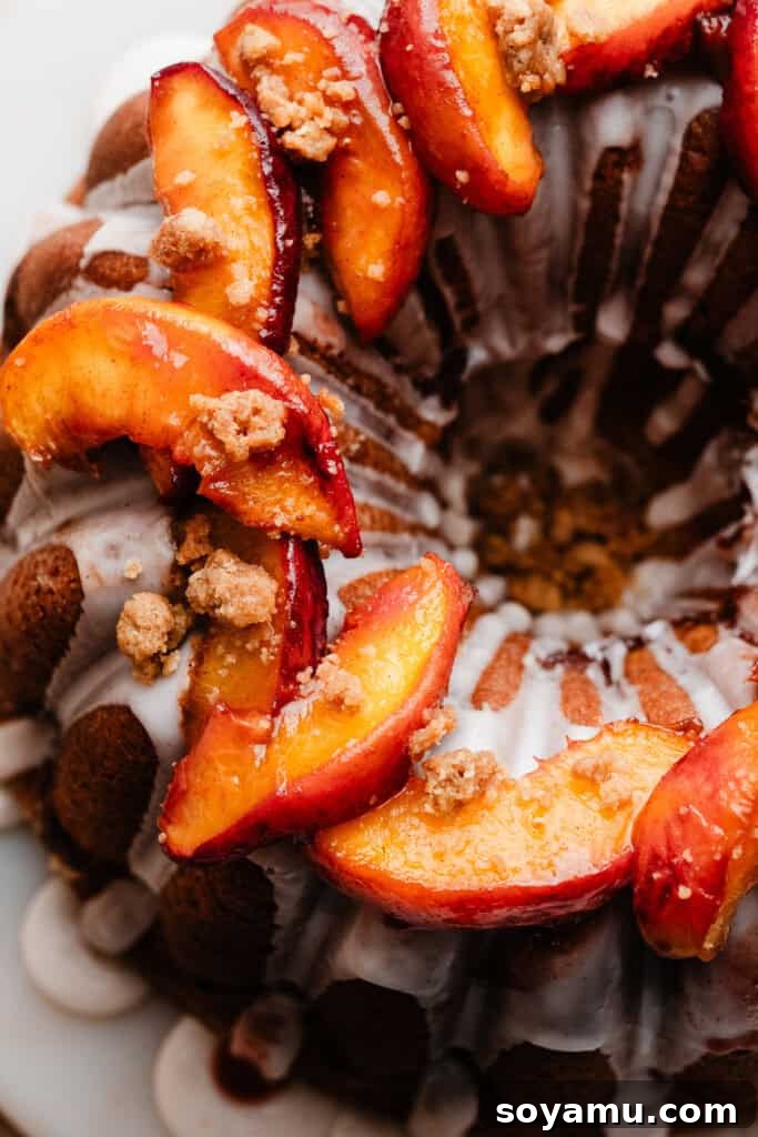 Caramelized Cinnamon Peaches 3 Roasted peach slices elegantly arranged on top of a delicious peach cobbler pound cake, showcasing their versatility as a dessert topping.
