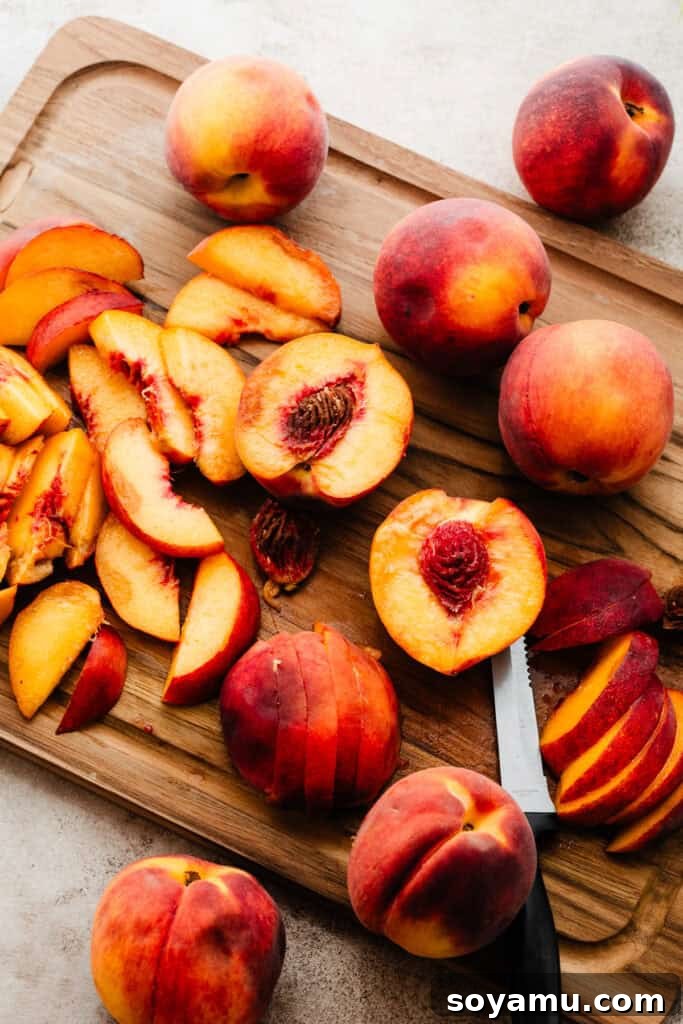 Caramelized Cinnamon Peaches 4 Freshly sliced ripe peaches arranged neatly on a cutting board, ready for seasoning and roasting.