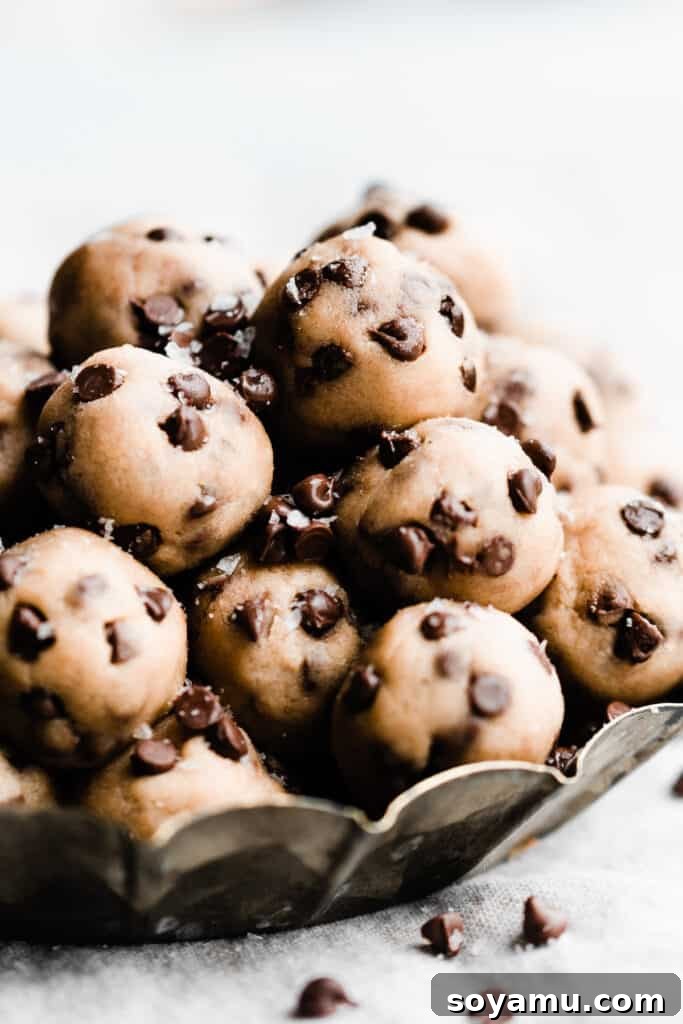 No-Bake Cookie Dough Poppers 2 A metal tray filled with numerous mini no-bake edible chocolate chip cookie dough bites.