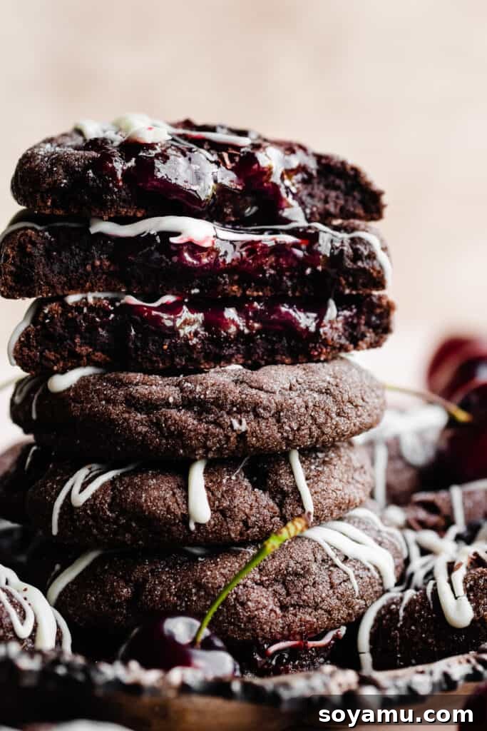 Midnight Forest Cherry Cookies 9 A close-up photograph of a perfectly stacked trio of Black Forest Cookies, highlighting their thick, decadent layers and inviting texture.