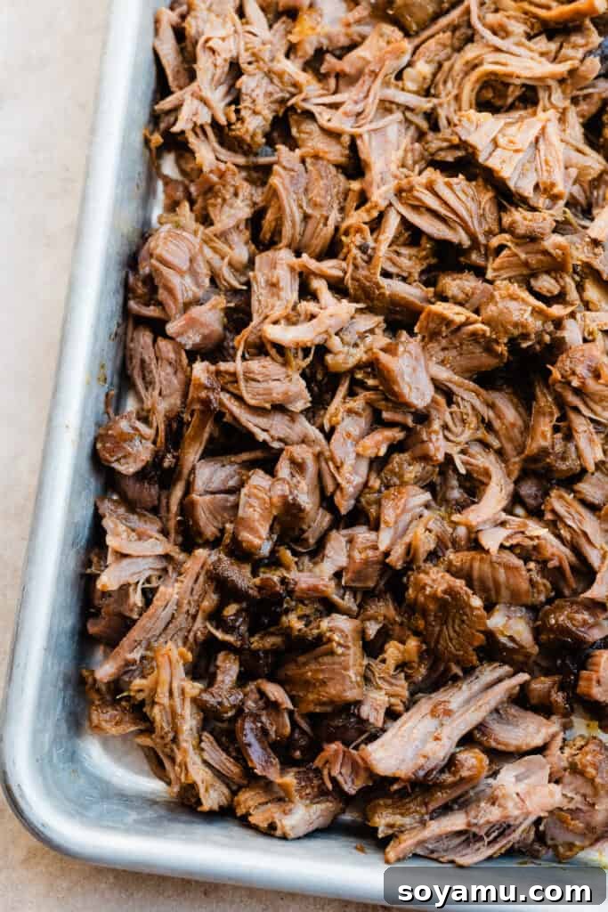 Melt-in-Your-Mouth One-Pot Lamb Barbacoa Tacos 7 A tray filled with freshly shredded lamb meat, juicy and ready for taco assembly.