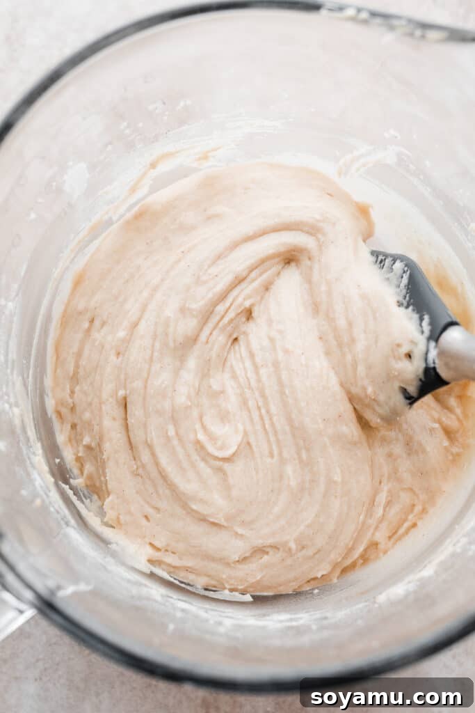 A close-up of the smooth, thick cake batter in a mixing bowl.