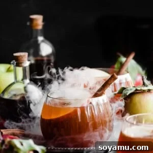 Glasses of the cocktail with swirls of dry ice coming up around it.