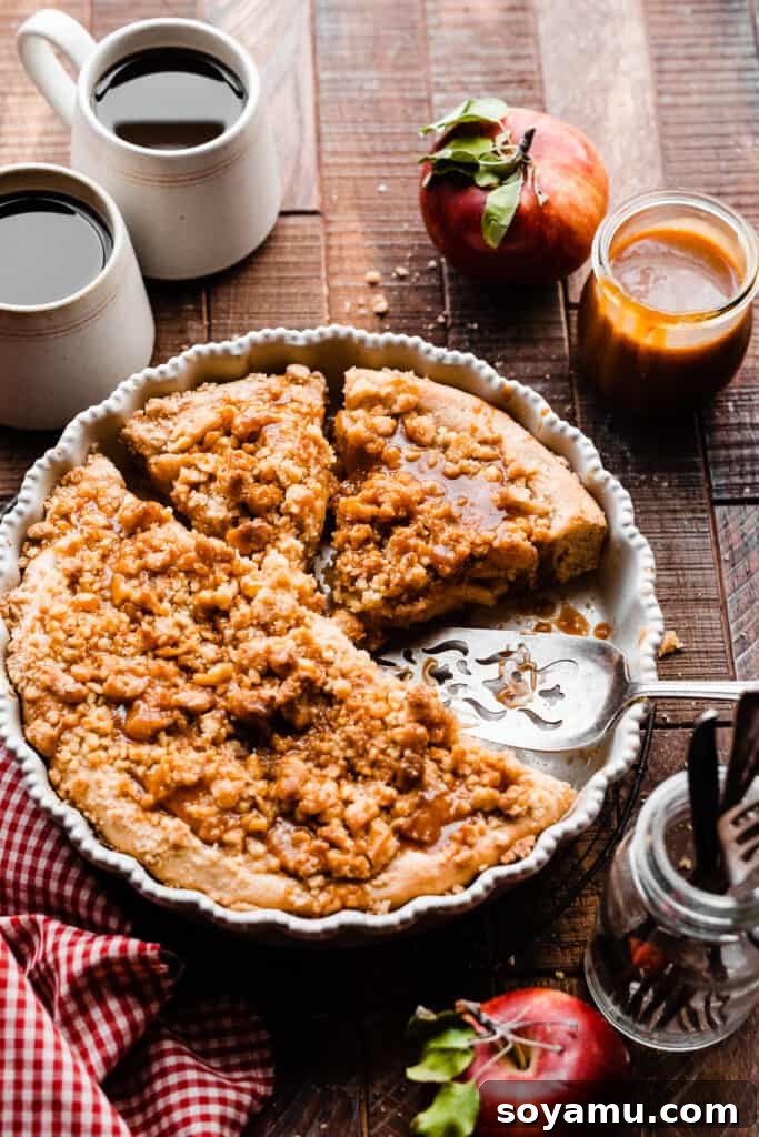 Decadent Caramel Apple Streusel Pizza 3 The whole sliced dessert pizza in the pan, beautifully topped with drizzled salted caramel sauce.