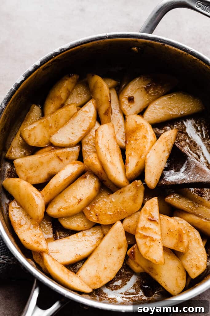 Decadent Caramel Apple Streusel Pizza 6 A pan of sliced, cooked apples simmering with spices, ready for the pizza.