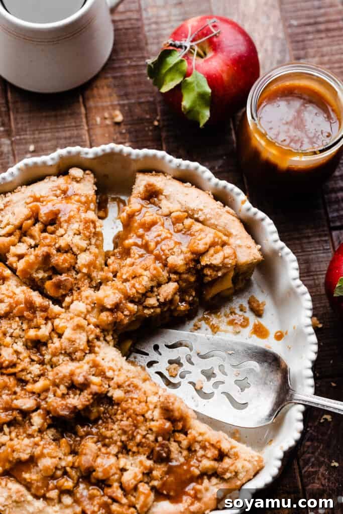 Decadent Caramel Apple Streusel Pizza 10 Multiple slices of the caramel apple dessert pizza displayed in the pie plate, showing its appealing texture and toppings.