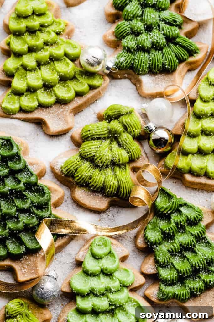 Honey Cream Dream Cookies 11 Honey cookies decorated like christmas trees on a sugary surface, with christmas ribbon and ornaments.